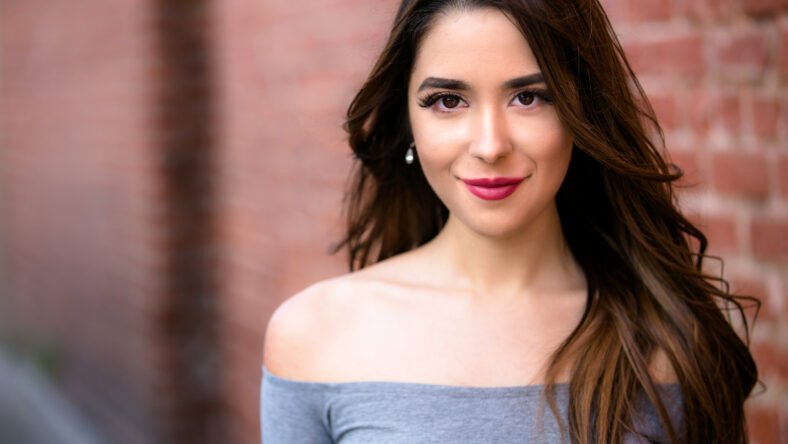 Beautiful young hispanic american woman with perfect skin, genuine casual smile