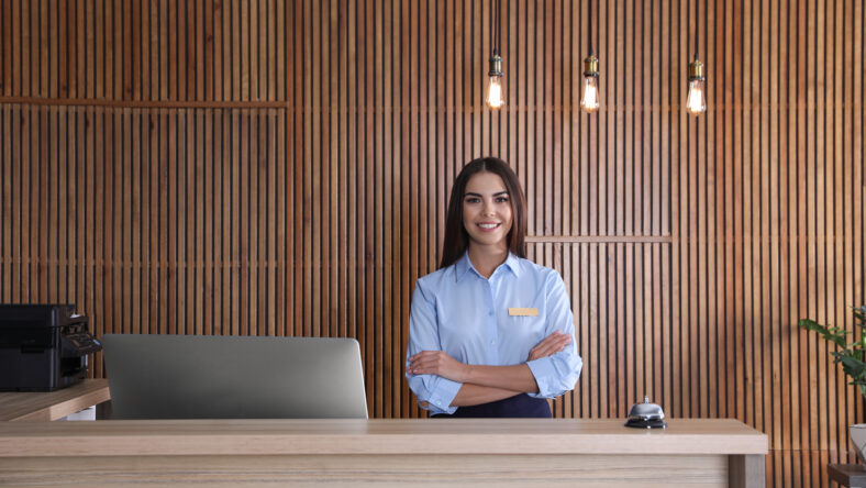Portrait of receptionist at desk in lobby