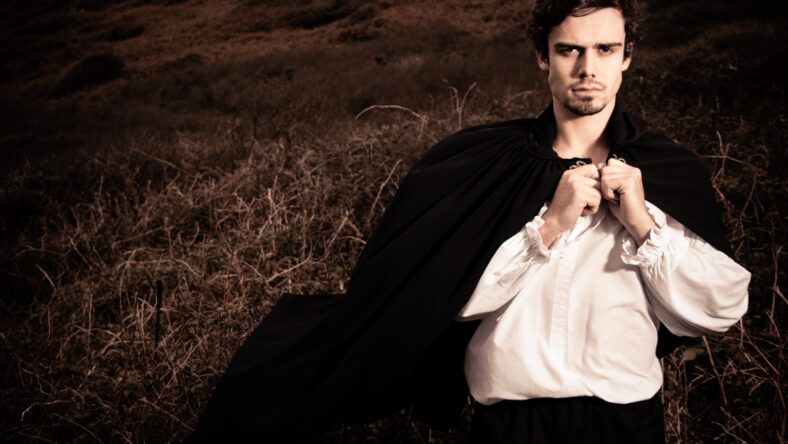 Handsome young male 18th century man in costume and came out on the moors