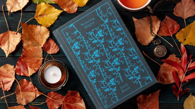 'Wuthering Heights' by Emily Bronte, shot from the top with a cup of tea and autumn leaves, the concept of reading in the fall