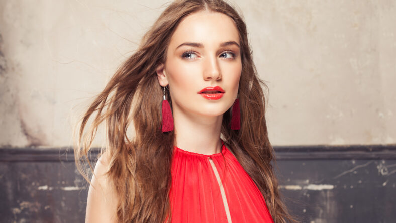 Attractive young female face with brown hair and makeup portrait