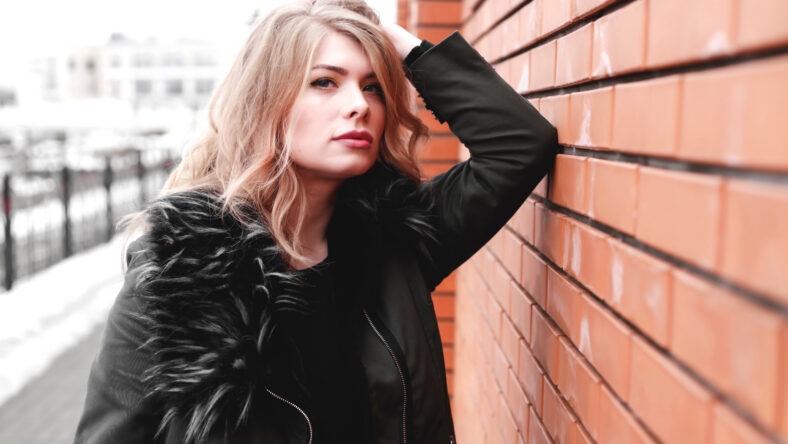 Pretty young woman walking on the city street. Casual fashion, plus size model.