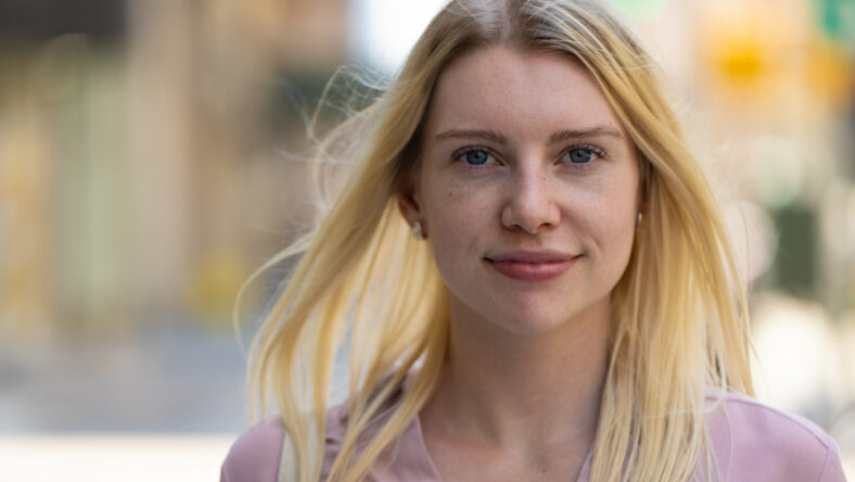 Young caucasian woman in city smile happy face portrait