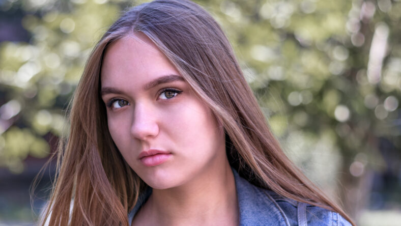 cute young girl 16 years old with long brown hair and brown eyes, close-up portrait