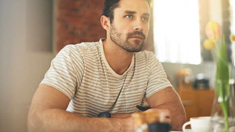 Waiting for inspiration to strike. A young man looking thoughtful while sitting in a coffee shop
