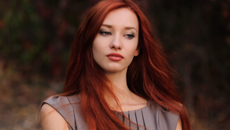 Outdoors portrait of beautiful young woman with red hair colorful autumn