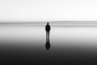 Silhouette of man standing alone on a