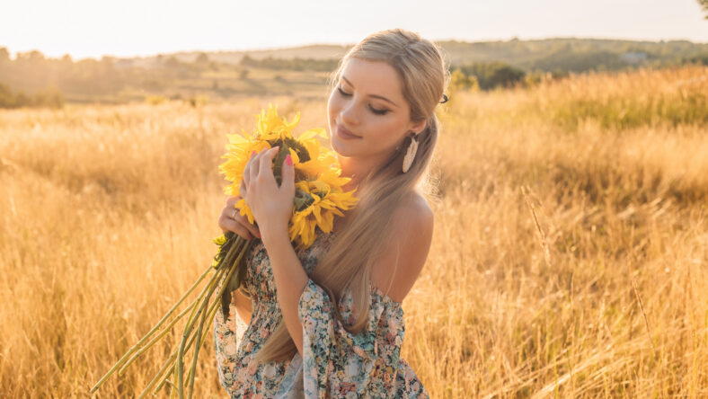 portrait of beautiful happy pregnant woman in countryside during sunset