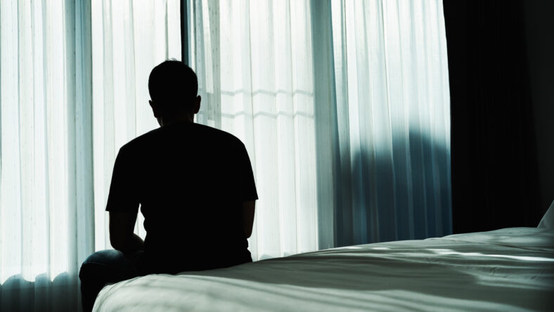 Silhouette depressed man sadly sitting on the