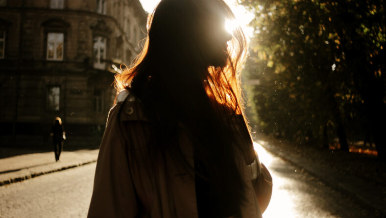 happy stylish woman having fun in sunny city street