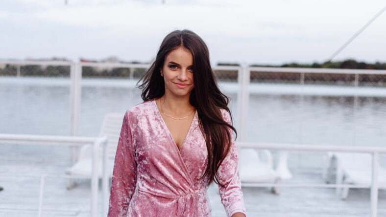fashion portrait of happy beautiful Hispanic latino girl in purple dress with long hair