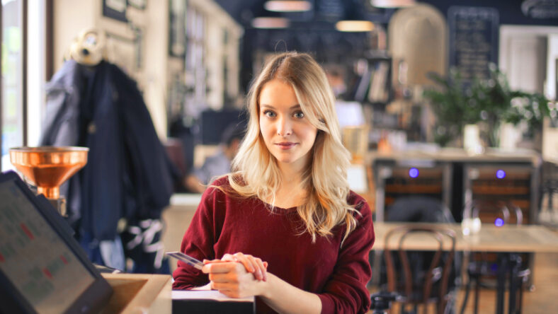 pretty blonde woman restaurant paying