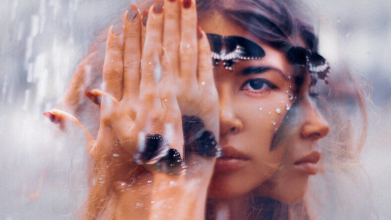 beautiful young woman with butterfly. conceptual. double exposure