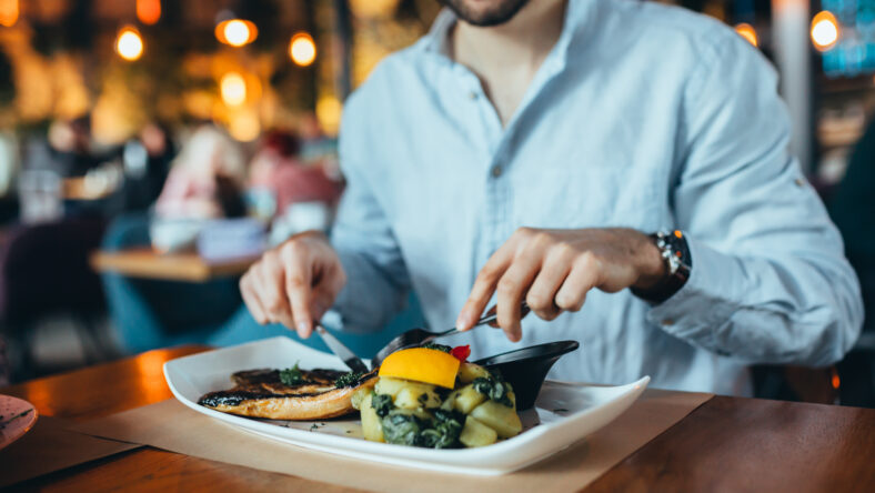 close up of man having lunch in restaurant