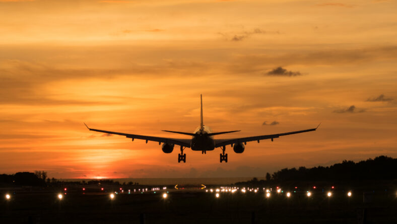 Silhouette Airplane will take-off at an airport during sunset sky