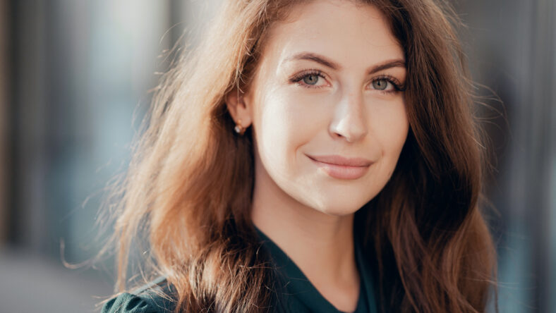 portrait of a confident business woman brunette in a formal dress goes to work in the office
