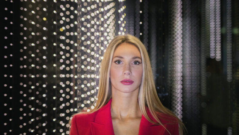 blonde woman in a red blazer