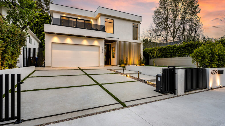 a garage and a driveway outside the house at dusk in los angeles, california