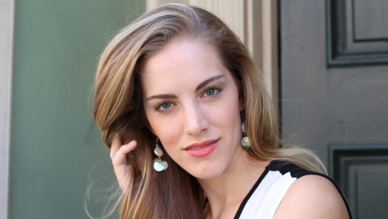 Portrait of naturally beautiful woman in her twenties with blond hair and blue eyes, shot outside in natural sunlight