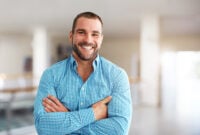 Smiling man standing in business center