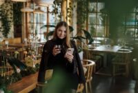 Beautiful young woman standing with smartphone and