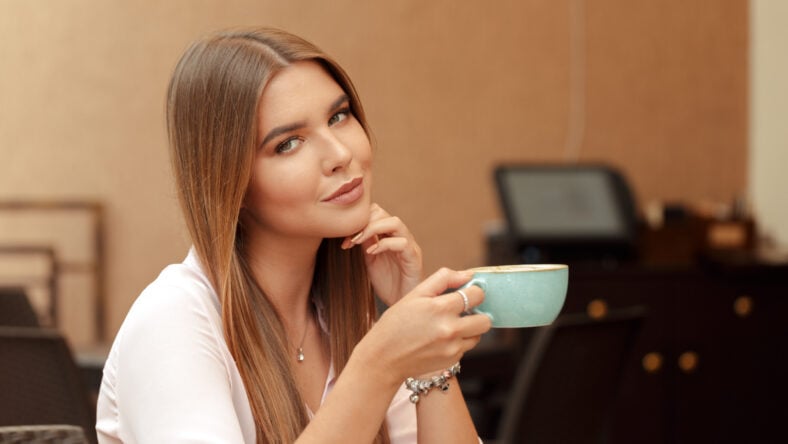 Young woman drinking coffee in a cafe