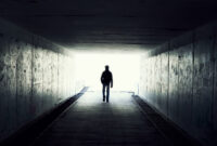 silhouette in a subway tunnel. Light at