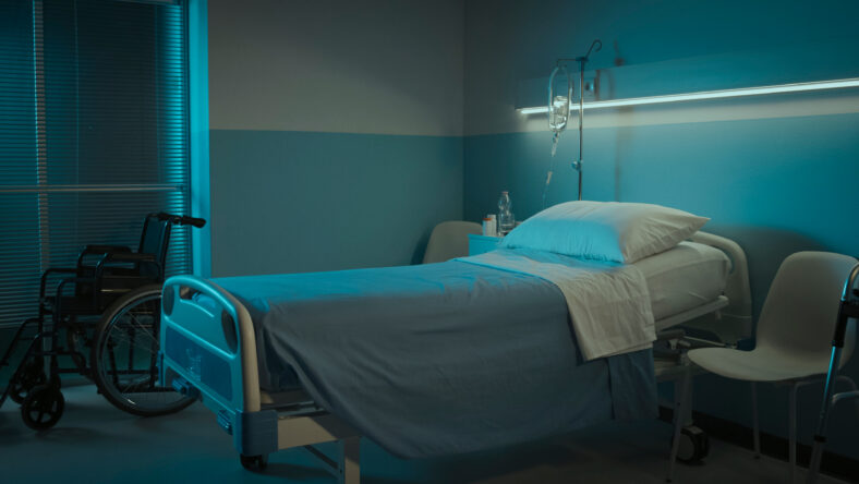 Clean hospital room interior at night with bed and medical equipment, medicine and healthcare concept