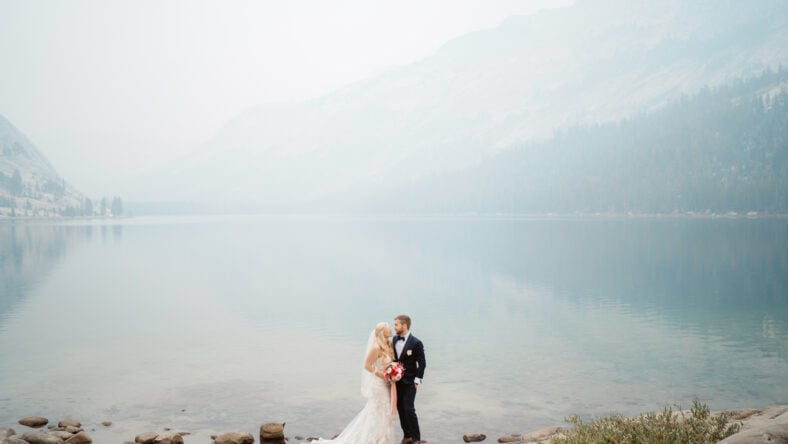 Couple romantically posing at elopement in foggy