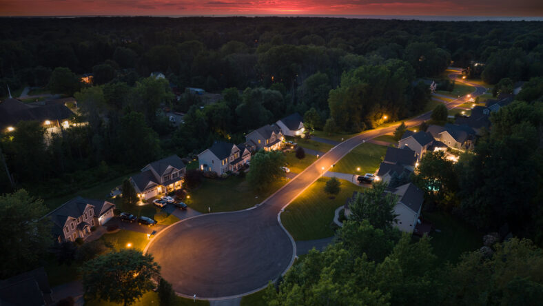 Low-density two story private homes at sunset. Rural street cul-de-sac dead end in residential suburbs with upscale suburban houses outside of Rochester, New York.