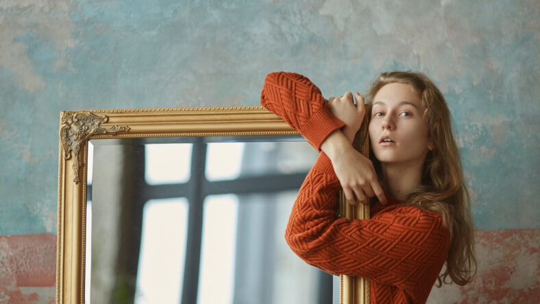 Dreamy young girl with long wavy amber