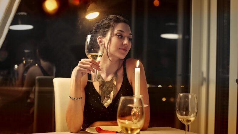 Elegantly-dressed woman sitting at a restaurant