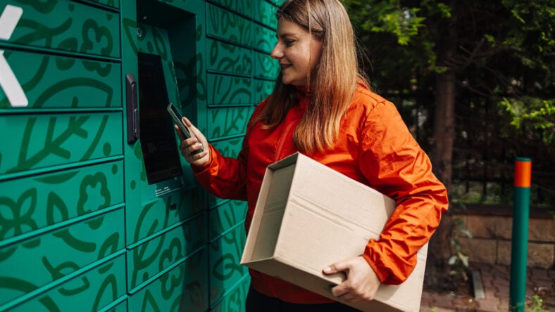 Caucasian woman picks up parcel from automatic
