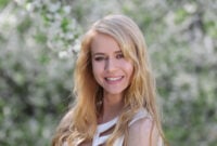 Young beautiful woman on blooming tree background