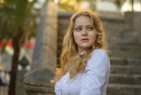 beautiful blond woman in white posing, stairs
