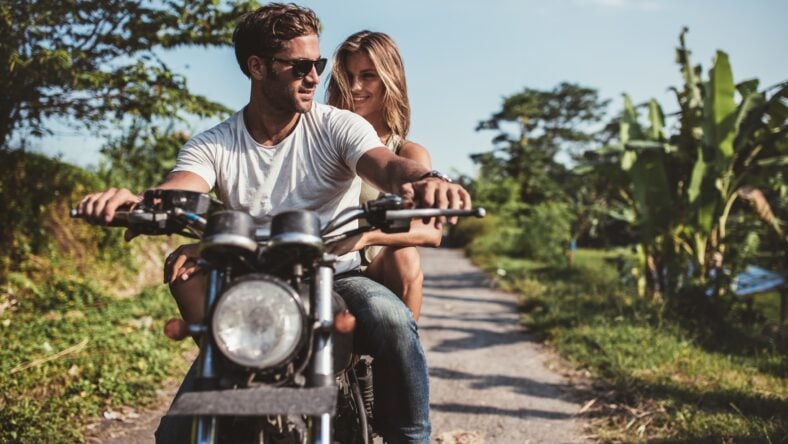 Shot of young couple on motorcycle. Man