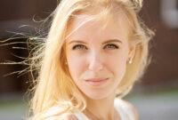 beautiful blond woman looking at camera outdoor