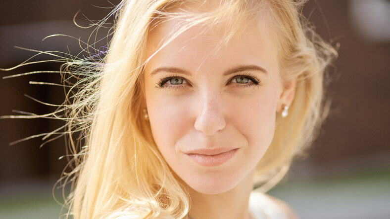 beautiful blond woman looking at camera outdoor