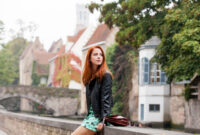 beautiful young woman sitting on the stone