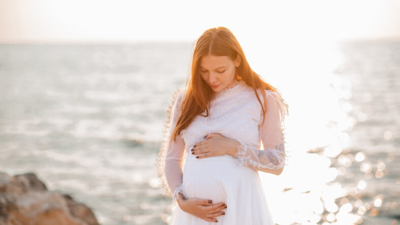 Happy pregnant woman 20-24 year old wearing