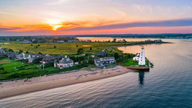 Lynde Point Lighthouse (also known as the Inner Light) and its adjacent keeper's house are viewed from an aerial perspective during a summer sunset in Old Saybrook, Connecticut, New England.