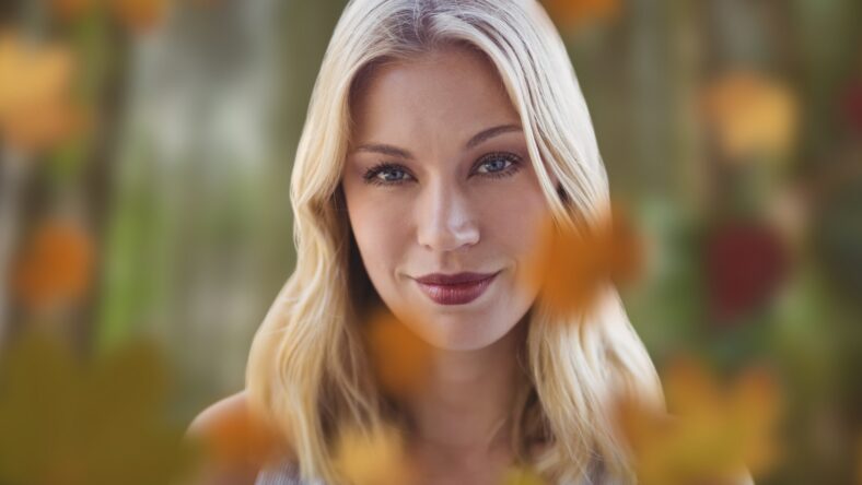 Woman's face in forest with leaves