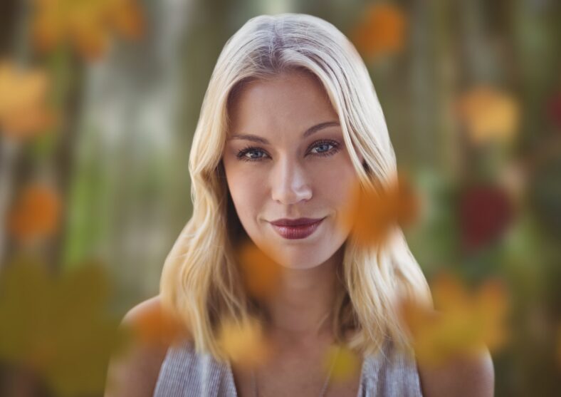Woman's face in forest with leaves