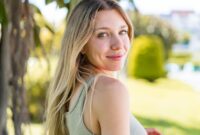 Young blonde woman at outdoors . Portrait