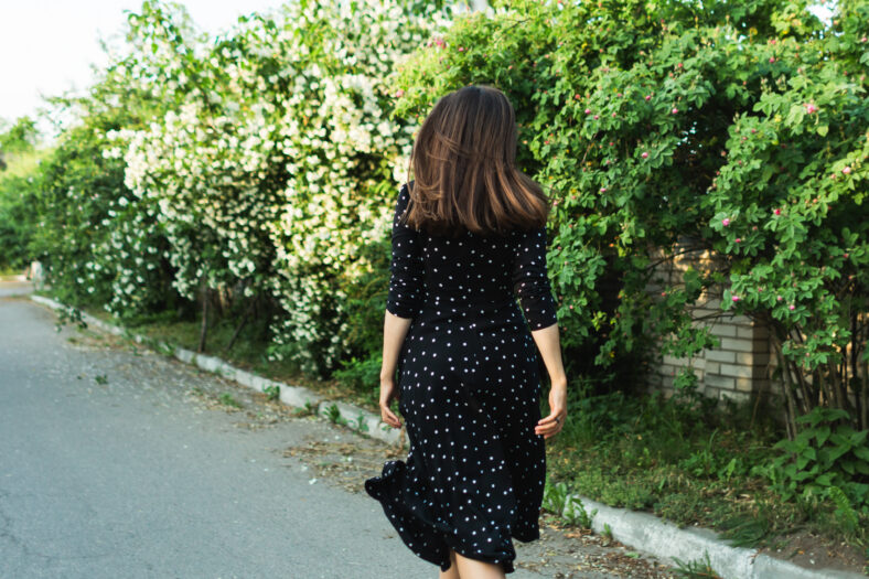 Back view of a brunette woman walking