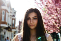 Charming young woman in pink dress poses