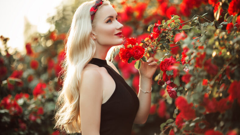 Beautiful smiling blonde woman in bush of