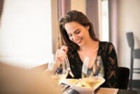 pretty young woman at a restaurant eating