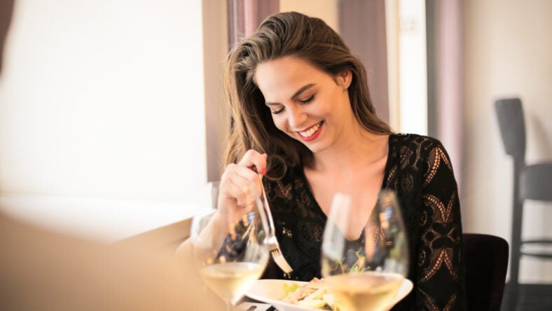 pretty young woman at a restaurant eating