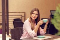 Young woman drinking coffee in a cafe